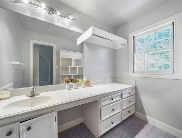 a bathroom with a sink double vanity and a mirror