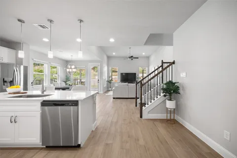 a kitchen with counter top space and wooden floor