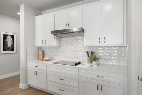 a kitchen with white cabinets and white appliances
