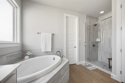 a bathroom with a tub and a shower