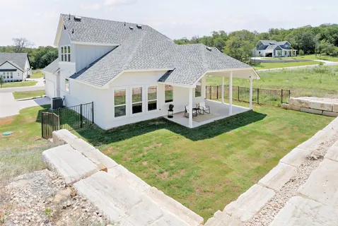 a view of a house with pool and a yard