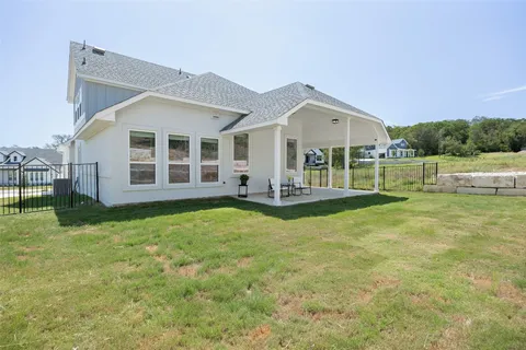 a view of a house with backyard and porch