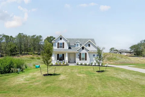 a front view of a house with a yard table and chairs