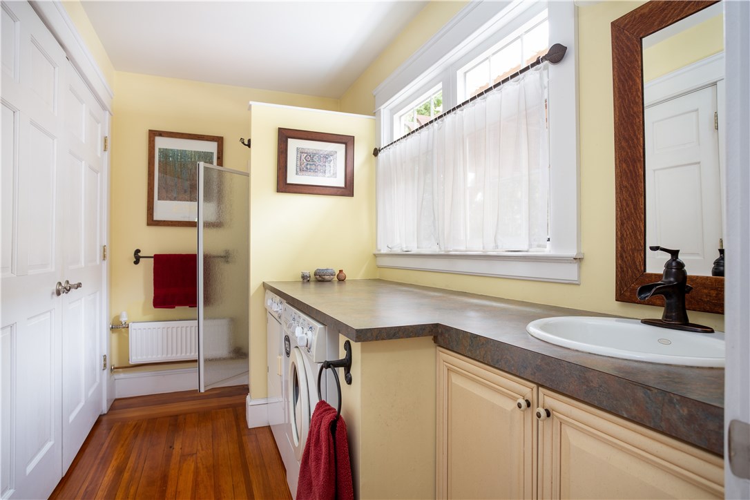 5359 Post Road East Greenwich, RI 02818 - Photo 16 of 38 First floor full bathroom with shower and lots of storage. Conveniently houses the washer and dryer.