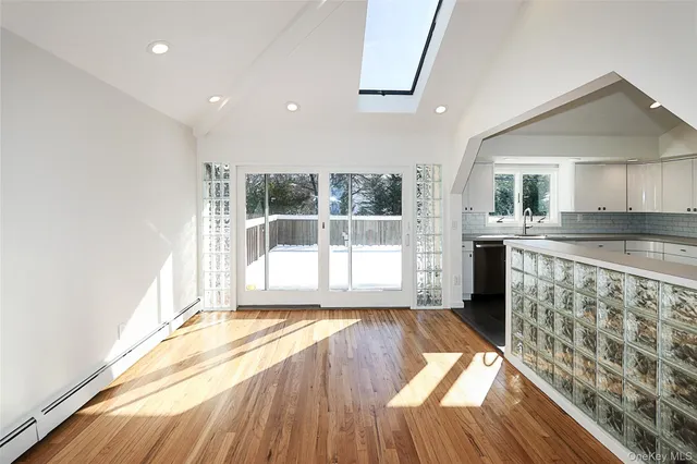 a open kitchen with granite countertop a stove top oven sink and cabinets