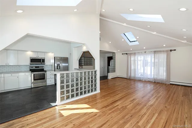a view of kitchen with furniture and stainless steel appliances