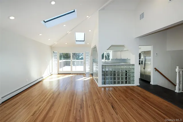 a view of a kitchen with wooden floor and a window