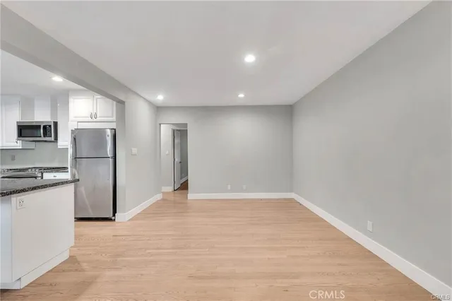 a view of kitchen with refrigerator stove microwave and cabinets