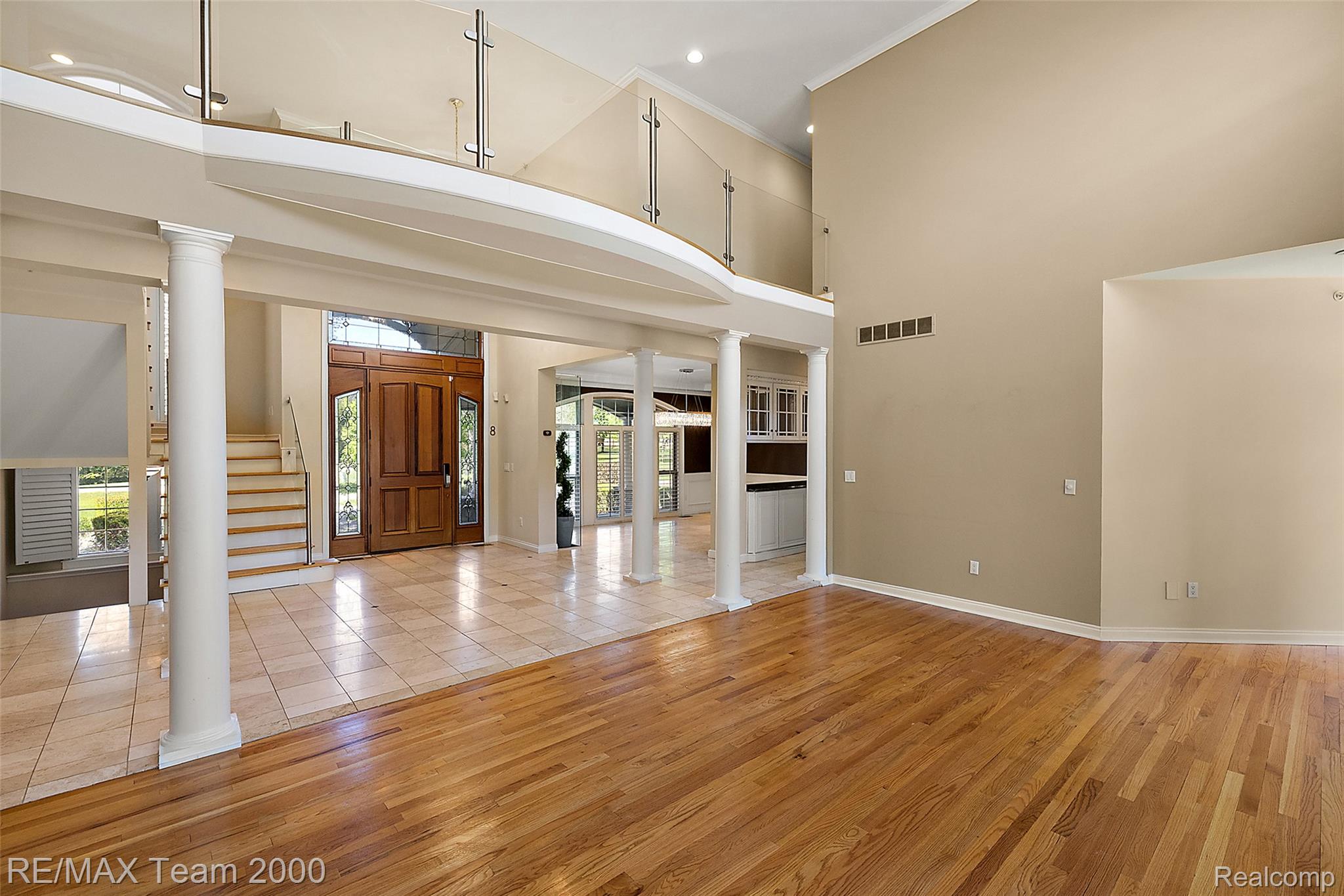 630 Sheldon Court Rochester, MI 48306 - Photo 20 of 94 Foyer with decorative columns, light wood finished floors, crown molding, recessed lighting, and a high ceiling