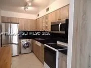 a kitchen with a stove and a refrigerator