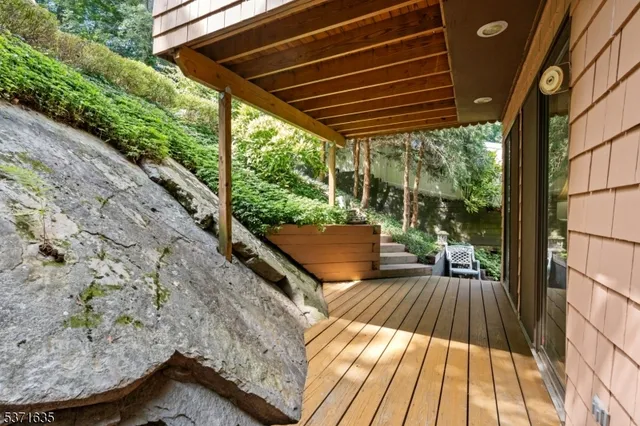 a view of backyard with green space and seating area