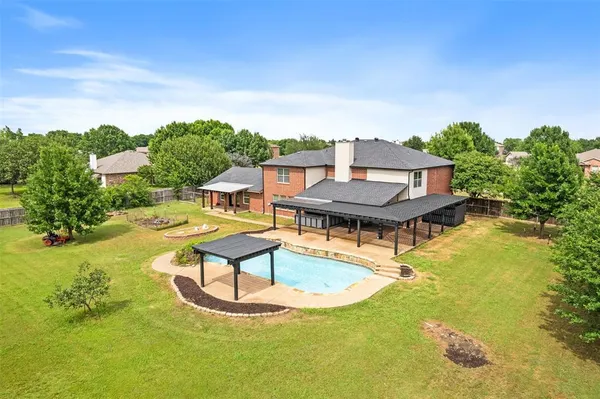 a view of a swimming pool with a yard