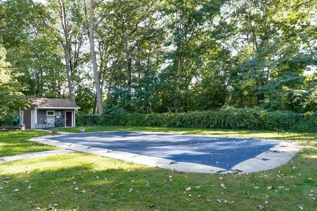 a view of yard with tree in front of it