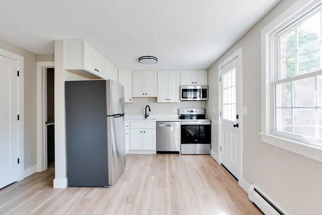 a kitchen with stainless steel appliances a refrigerator sink and cabinets
