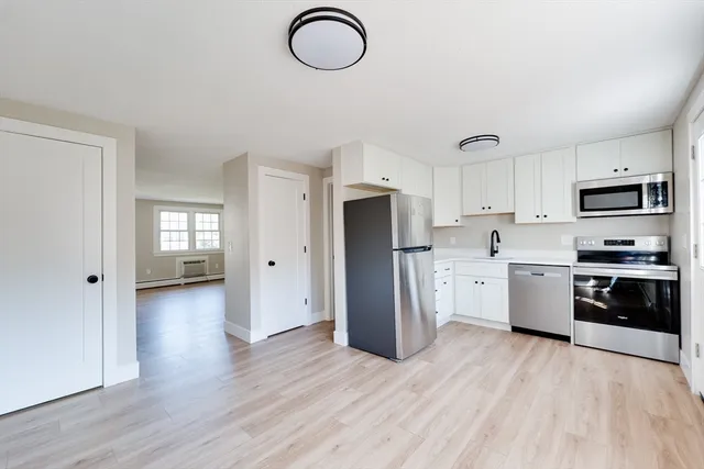 a kitchen with stainless steel appliances granite countertop a refrigerator stove top oven and sink