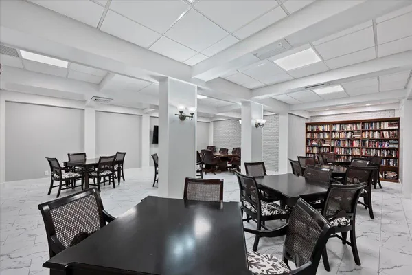 a dining room with furniture and wooden floor