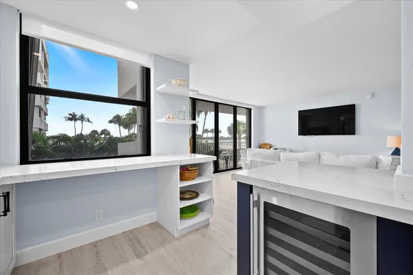 a view of kitchen with sink stainless steel appliances and cabinets