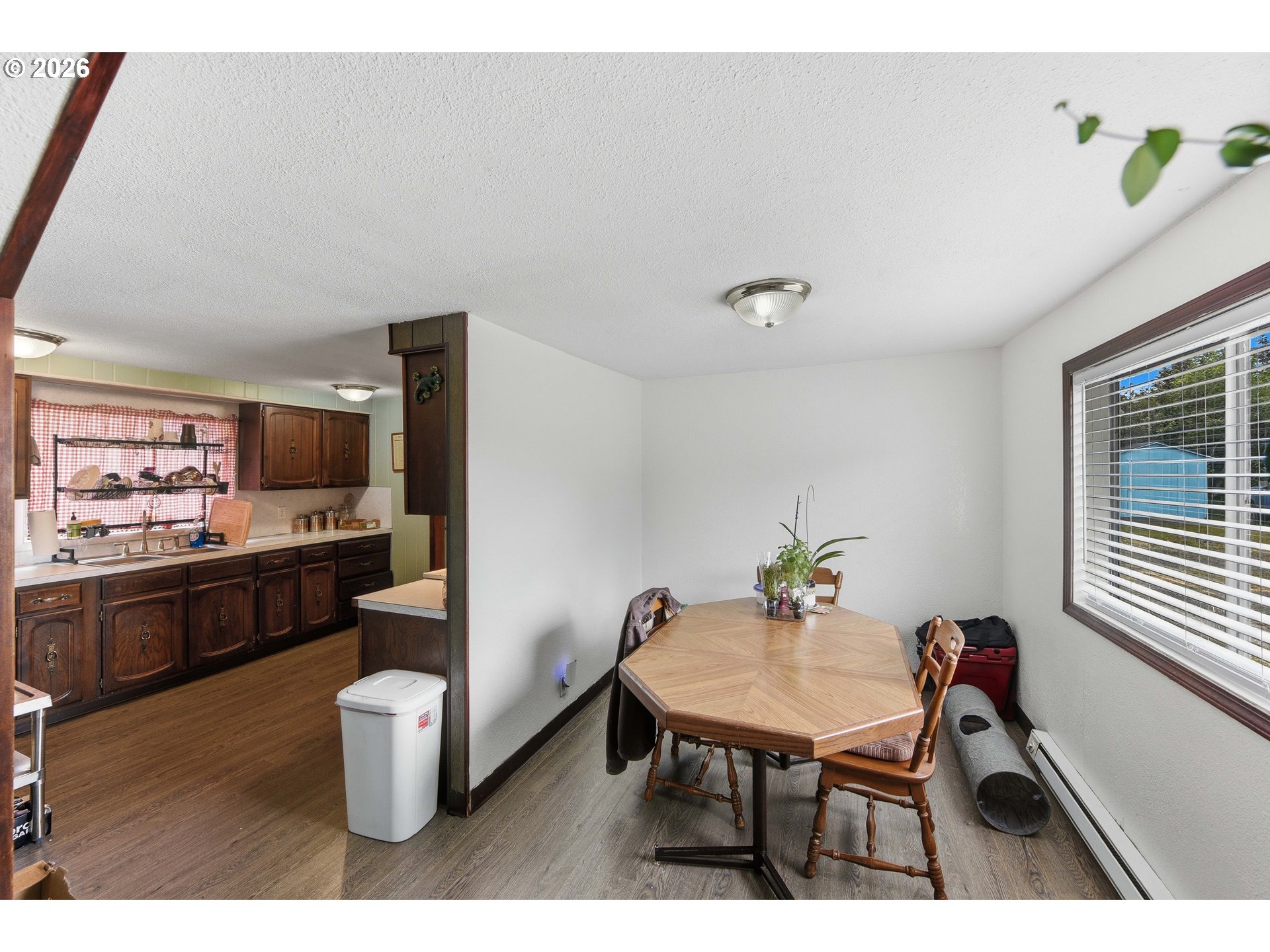 1955 Maple Street North Bend, OR 97459 - Photo 11 of 48 a view of a dining room with furniture window and wooden floor
