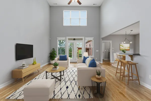 a view of a big room with wooden floor and a kitchen
