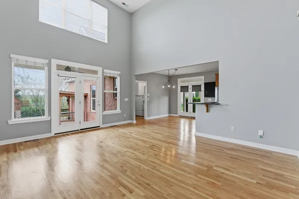 a view of a hallway with wooden floor and staircase