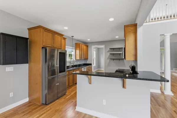 a kitchen with stainless steel appliances granite countertop a stove a sink and a microwave