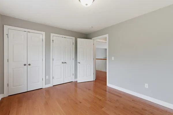 a bathroom with double vanity sink a vanity a window and a mirror