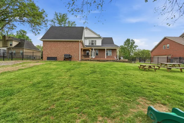a view of backyard of house with green space