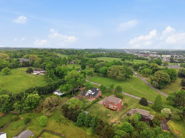 an aerial view of residential houses with outdoor space and swimming pool