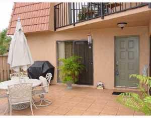 a view of a patio with table and chairs and potted plants
