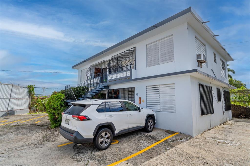Undisclosed Address San Juan, San Juan 00921 - Photo 2 of 33 a car parked in front of a house