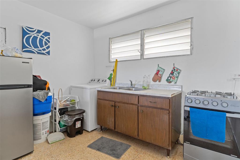 Undisclosed Address San Juan, San Juan 00921 - Photo 22 of 33 a room with kitchen island and a window