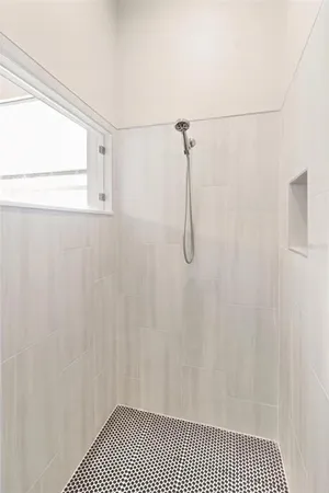 a bathroom with a shower curtain and a window