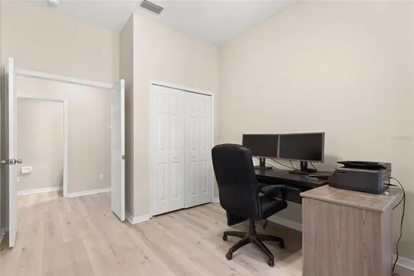 a view of a workspace with furniture and a window