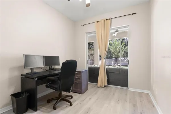 a view of a workspace with furniture and a window