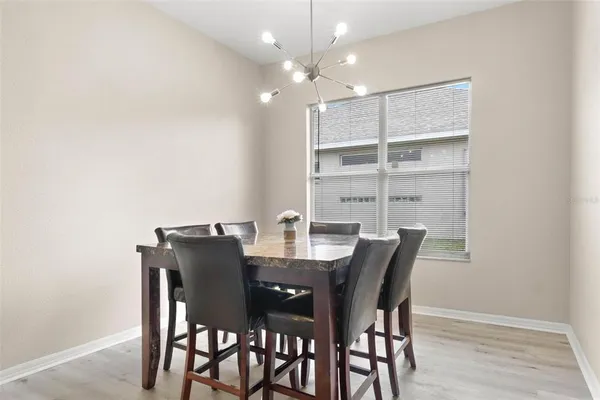 a view of a dining room with furniture and wooden floor