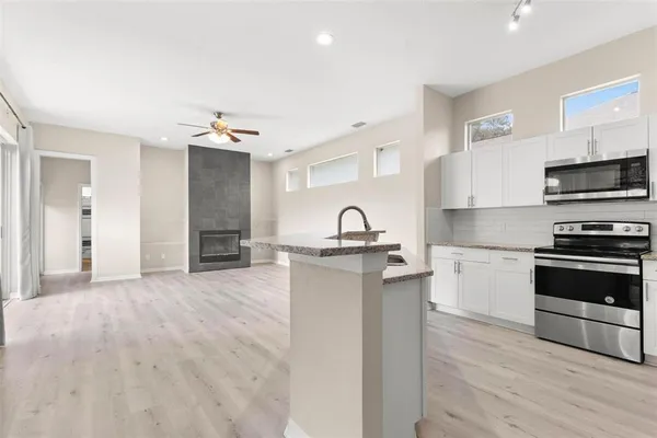 a kitchen with stainless steel appliances granite countertop a stove and a sink