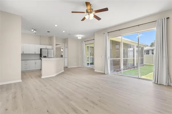 a view of a kitchen with wooden floor and a ceiling fan