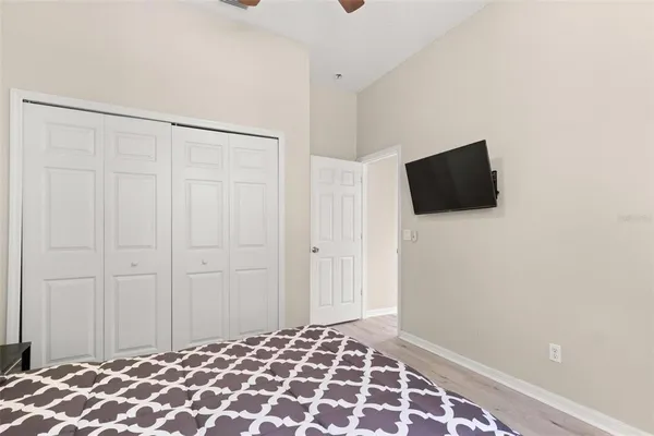 a bedroom with a bed and a flat screen tv