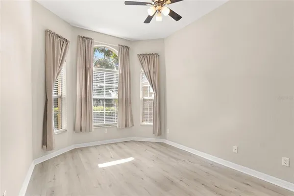 an empty room with windows and closet