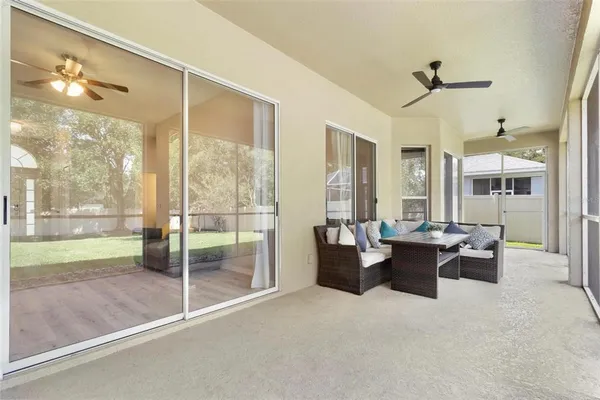 a view of a livingroom with furniture and floor to ceiling window