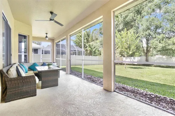 a living room with furniture and floor to ceiling windows