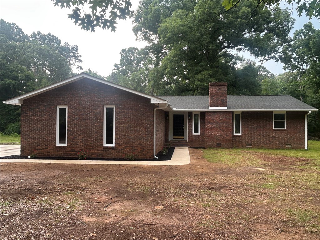 809 Paige Road Honea Path, SC 29654 - Photo 25 of 27 This classic brick residence, surrounded by mature trees, offers a timeless facade with a welcoming entrance.