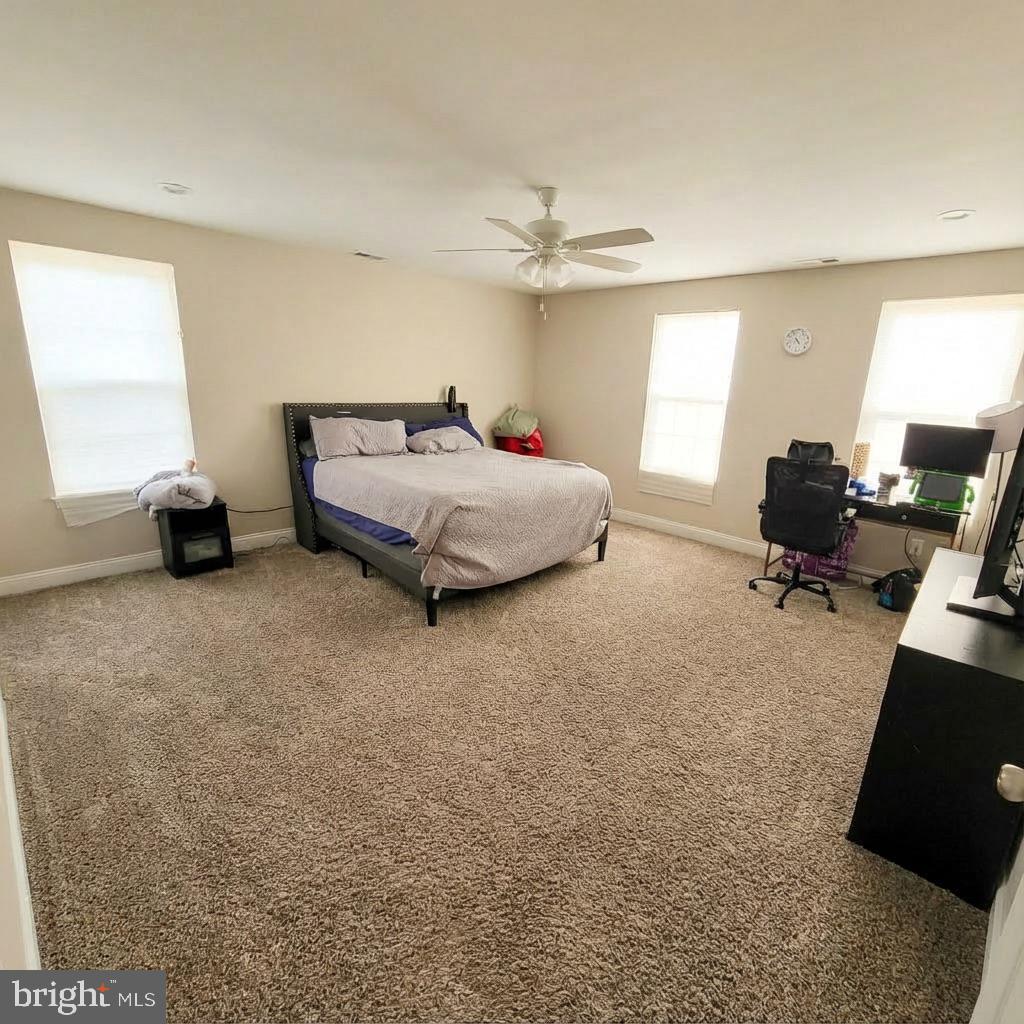 10 West Monroe Street Mount Holly, NJ 08060 - Photo 11 of 16 a spacious bedroom with a bed and a chandelier