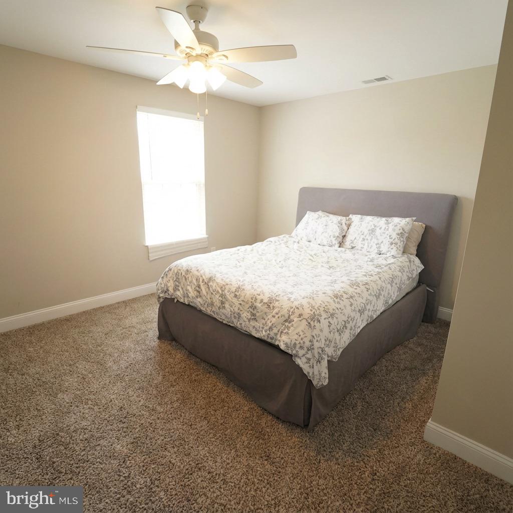 10 West Monroe Street Mount Holly, NJ 08060 - Photo 14 of 16 a bed sitting in a bedroom next to a window