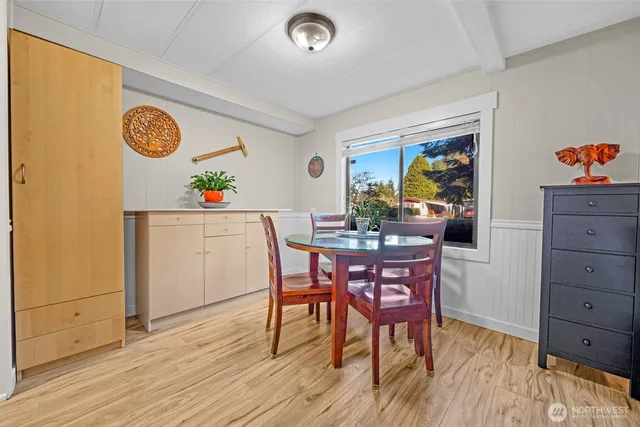 a dining room with furniture and wooden floor