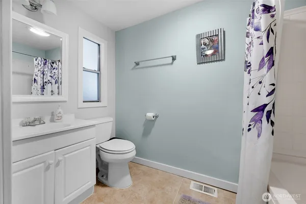 a bathroom with a toilet a sink and a mirror