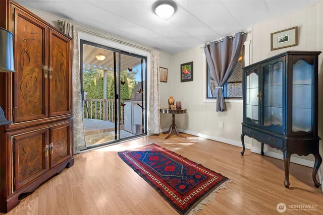 a living room with hard wood floors and a rug