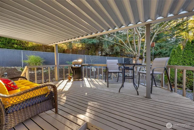 a view of a patio with table and chairs and wooden floor