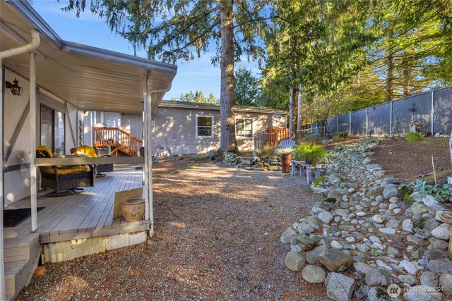 a backyard of a house with barbeque oven and outdoor seating