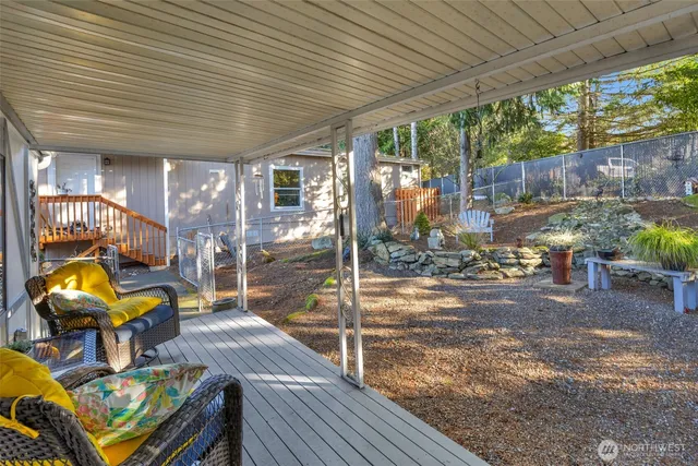 a view of a patio with table and chairs potted plants with wooden floor